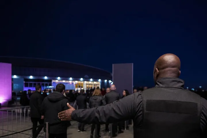 Argus United Services security officer managing crowd access at an event entrance