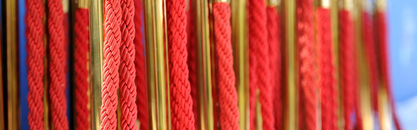 Gold stanchions and red velvet rope marking a venue entrance